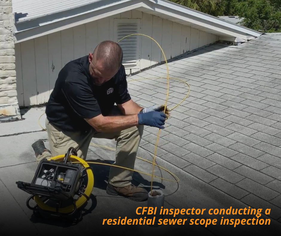 Home inspector feeding a sewer scope camera into a cleanout during a Florida sewer scope inspection